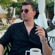 ikødev wearing sunglasses and a black shirt outdoors